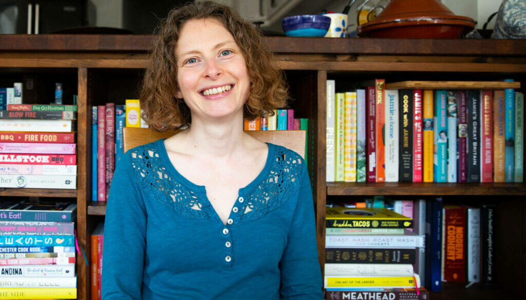 Sarah Alder in Front of Book Shelf