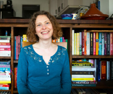 Sarah Alder in Front of Book Shelf